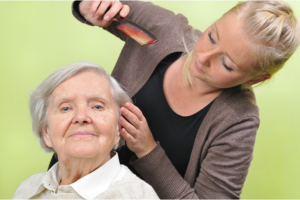 caregiver combing her patient