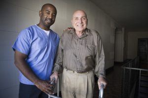 caregiver assisting his patient in walking