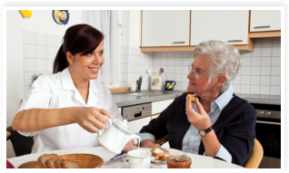 caregiver preparing meal for her patient